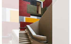 Staircase with wall painted with coloured squares; Photo by Brett Jordan from Pexels
